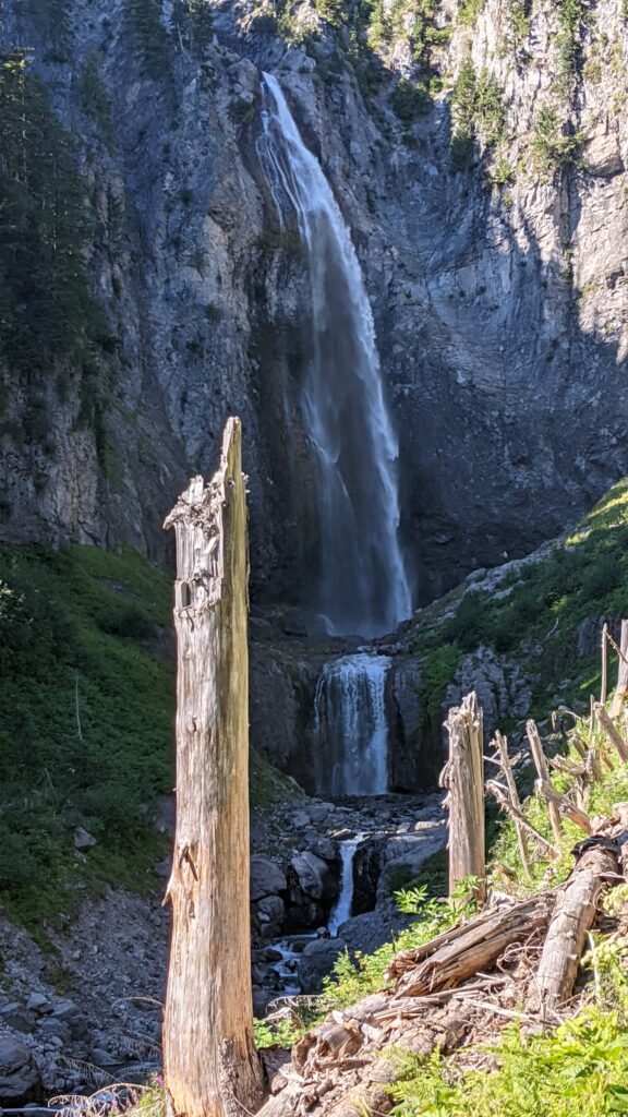 Comet Falls cascading down a massive rugged stone cliffside in Mount Rainier National Park, an iconic destination featured on our guided hikes in Seattle, WA.
